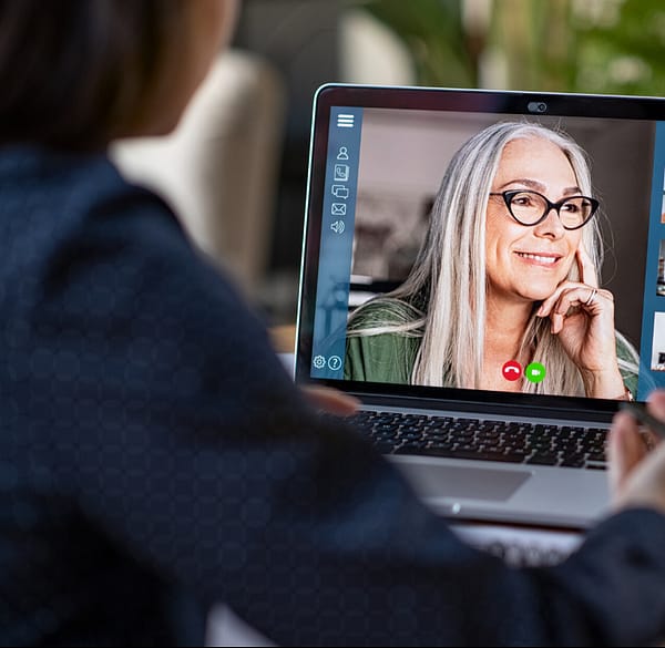 laptop showing two people on a video call